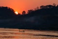 Sunset over mountain and river in silhouette Royalty Free Stock Photo