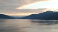 Sunset over the Mountains breaking through heavy cloud cover on the Pacific Ocean in Alaska United States of America Royalty Free Stock Photo