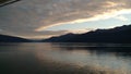 Sunset over the Mountains breaking through heavy cloud cover on the Pacific Ocean in Alaska United States of America Royalty Free Stock Photo