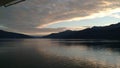 Sunset over the Mountains breaking through heavy cloud cover on the Pacific Ocean in Alaska United States of America Royalty Free Stock Photo