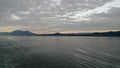 Sunset over the Mountains breaking through heavy cloud cover on the Pacific Ocean in Alaska United States of America Royalty Free Stock Photo