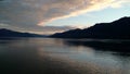 Sunset over the Mountains breaking through heavy cloud cover on the Pacific Ocean in Alaska United States of America Royalty Free Stock Photo