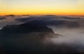 Sunset over the mountains in the clouds Royalty Free Stock Photo