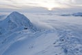 Sunset over the mountains and clouds in winter Royalty Free Stock Photo