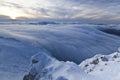 Sunset over the mountains and clouds in winter Royalty Free Stock Photo