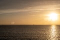 Sunset over Mykonos island, Cyclades, Greece. Lighthouse, orange yellow sky sparkle sea. Vertical Royalty Free Stock Photo