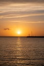 Sunset over Mykonos island, Cyclades, Greece. Lighthouse, orange yellow sky sparkle sea. Vertical Royalty Free Stock Photo