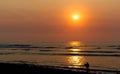 Coastal sunset with young surfer in silhouette Royalty Free Stock Photo