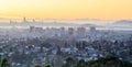 Sunset over Oakland and San Francisco Hazy Skylines. Royalty Free Stock Photo