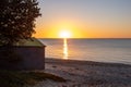 Sunset over ocean beach with bathing box. Royalty Free Stock Photo