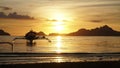 Sunset over the ocean with boats at El Nido Beach in Philippines. Royalty Free Stock Photo