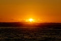 Sunset over ocean through the clouds from Waikiki beach Royalty Free Stock Photo