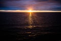 Sunset over Ocean on a Dark Cloudy Evening Royalty Free Stock Photo