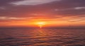 Sunset Over the Ocean with Orange and Red Sky and Water Reflections Royalty Free Stock Photo