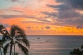 Sunset over the ocean with palm trees in Oahu, Hawaii Royalty Free Stock Photo