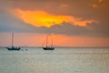 Sunset over ocean with small boat silhouette Royalty Free Stock Photo