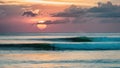A sunset over the ocean with surfers riding waves, AI Royalty Free Stock Photo