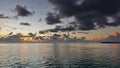 Sunset over the ocean. There are picturesque purple and pink clouds