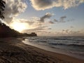 Sunset over the ocean with waves moving to shore Royalty Free Stock Photo