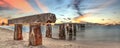Sunset over old abandoned stone fishing pier called Bocahenge Royalty Free Stock Photo