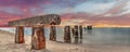 Sunset over old abandoned stone fishing pier called Bocahenge Royalty Free Stock Photo