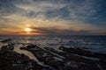 Sunset over the Pacific Ocean at a rocky beach in San Diego Royalty Free Stock Photo