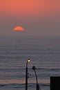 Sunset over the Peruvian Pacific with building reference and public lighting Royalty Free Stock Photo