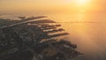 Sunset over pier town at ocean bay aerial. Amazing sun set light at marina seascape. Ships, yachts Royalty Free Stock Photo