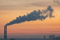 Sunset over power plant with smokestacks, orange and blue sky, industrial structure contrasting soft light. m Royalty Free Stock Photo