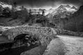 Sunset over the Pyrenees mountains, Circus of Gavarnie and the old stone bridge spanning the stream Royalty Free Stock Photo