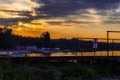 Sunset over the recreational lake, you can see ducks and boats. Beautiful orange colors, big contrast. Holidays and rest. Royalty Free Stock Photo