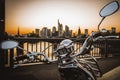 Sunset over the river Main in Frankfurt. View of the skyline with a bridge in the foreground. Cityscape with motorbike