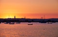 Sunset over the river Tejo, 25th of April Bridge and statue of Royalty Free Stock Photo