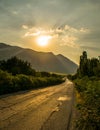 Sunset over the road near the mountains Royalty Free Stock Photo