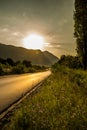 Sunset over the road near the mountains Royalty Free Stock Photo