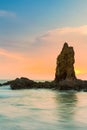 Sunset over rock in seacoast skyline Royalty Free Stock Photo