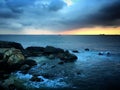 Sunset over the rocks in the Indian Ocean with the storm clouds near Galle, Sri Lanka, March 2019 Royalty Free Stock Photo