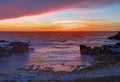 Sunset over rocks and sand at Asilomar State Beach in California Royalty Free Stock Photo