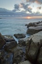 Sunset over rocky beach Royalty Free Stock Photo