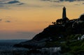 Sunset over rocky coast of Cap Ferrat cape with Phare Lighthouse near Saint-Jean-Cap-Ferrat resort town and Nice in France Royalty Free Stock Photo