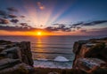 Sunset over a rocky coastline with large cliffs flanking both sides Royalty Free Stock Photo