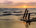 Sunset over ruined old pier pilings at Fort Funston Beach Royalty Free Stock Photo