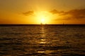 Sunset over sailing boats and reflecting on the Pacific ocean on the water