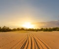 Sunset over the sandy desert with road far away Royalty Free Stock Photo