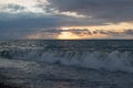 Evening seascape with waves. Sunset over the sea on a cloudy day. Royalty Free Stock Photo