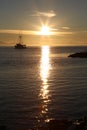 Sunset over the sea with boat silhouette