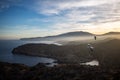 Sunset over sea cliffs and low clouds with clear sky and two seagulls Royalty Free Stock Photo