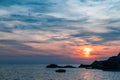 Sunset over the sea, colorful clouds, wide shot. Romantic picture full of colors