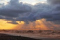 Sunset over sea with dramatic sky sky, dark storm clouds, and red light Royalty Free Stock Photo