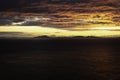 Sunset over sea with dramatic sky and islands on horizon Royalty Free Stock Photo